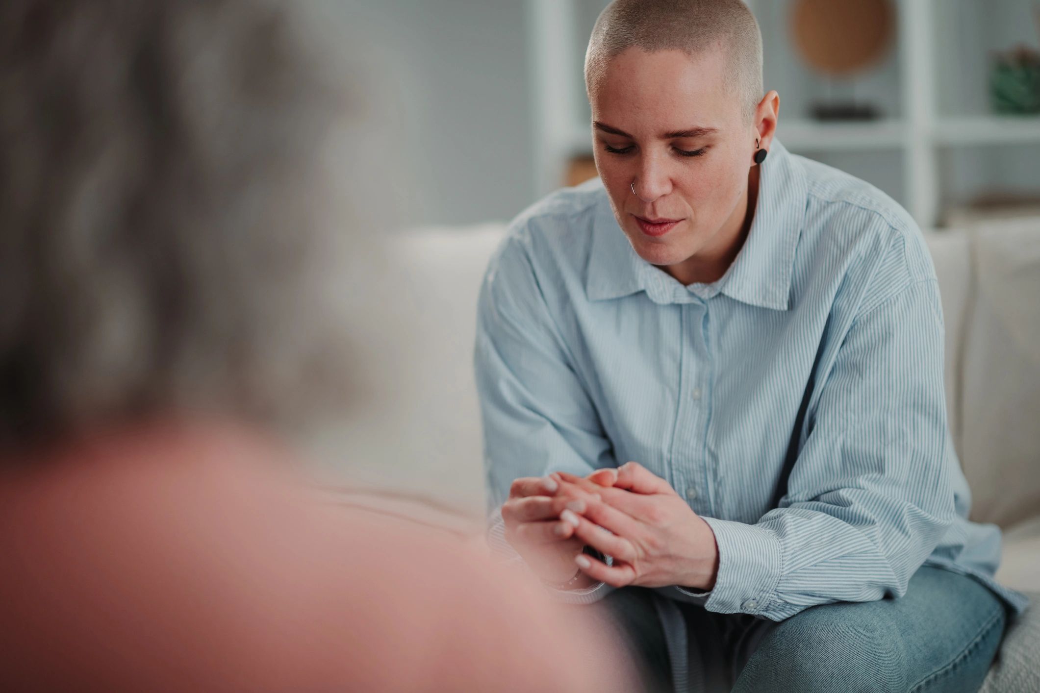 Person talking with counselor in a calm therapy setting